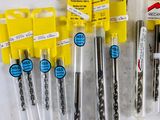 many different types of drill bits on the table