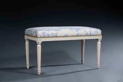 a white bench with a blue and white upholstered seat