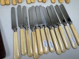 a lot of knives and knives that are on a table