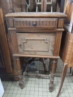 a small wooden table with a drawer on top of it