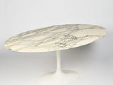 an oval marble table with a white base and a white base