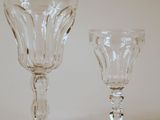 two wine glasses sitting next to each other on a table