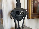 a statue of a bird on top of a table next to a mirror