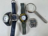 three watches and a magnifying glass on a table