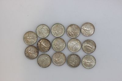 several quarters of coins are arranged in a row on a white surface