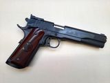 a close up of a gun on a table with a white background