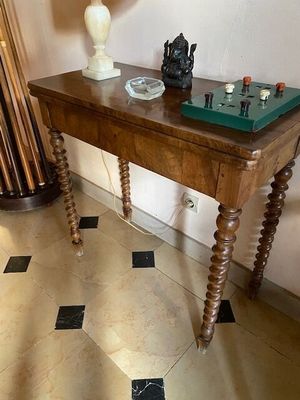 a wooden table with a lamp on top of it