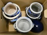 three blue and white vases in a cardboard box
