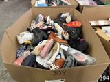 a box full of shoes that are sitting on the floor