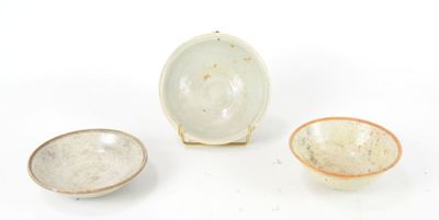 three small bowls and a small bowl are sitting on a white surface