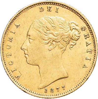 a close up of a gold coin with a woman ' s face