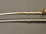 a close up of two swords on a gray surface