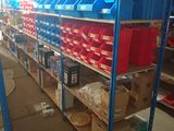 many shelves with bins on them in a warehouse