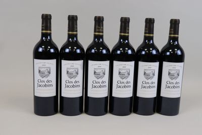 six bottles of red wine lined up in a row on a table