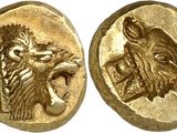 a close up of two gold coins with animals on them