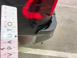 a parking meter on the street next to a parked car
