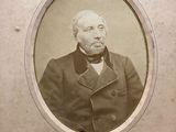 an old photo of a man in a suit and bow tie