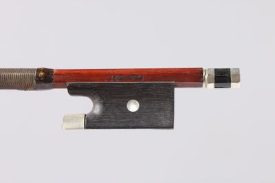 a violin bow with a wooden handle on a white surface