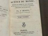 an open book with a picture of a clock on it