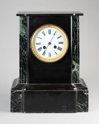 a black and gold clock with roman numerals on it