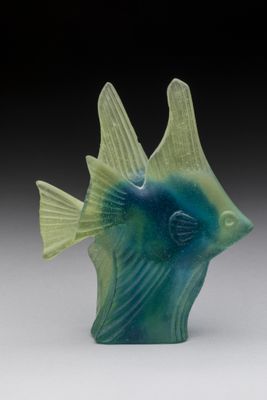 a blue and green fish figurine sitting on a table