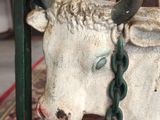 a statue of a bull with a chain around it ' s neck