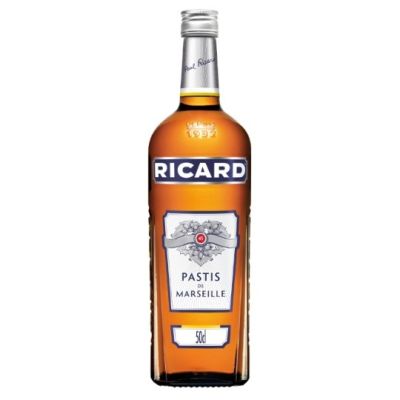 a bottle of ricard wine sitting on top of a white table