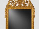 a mirror that is sitting on the floor in front of a wall