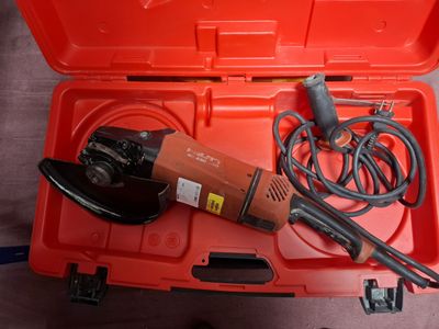 une boîte à outils rouge contenant une perceuse et un cordon d'alimentation