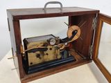 a wooden box with a clock inside of it