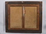 an old picture of a wooden frame with a knife in it