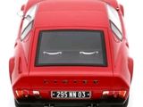 a red car that is sitting on a white surface