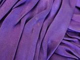 close up of a purple dress with ruffles on it