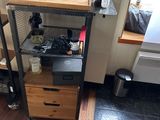 une photo d'une cuisine avec un micro-ondes et une étagère