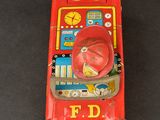 a red toy phone that is sitting on a table