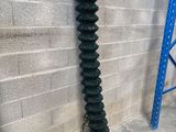 a hose attached to the side of a building next to a brick wall