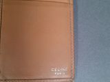 someone is holding a wallet with a name on it on a table