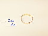 two wedding rings on a table with a price tag