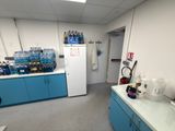 a photo of a kitchen with blue cabinets and a white refrigerator