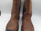 brown leather boots with black soles on a white surface