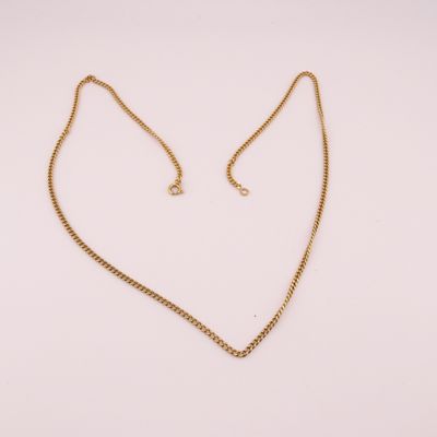 un collier en or avec un pendentif en forme de cœur sur une chaîne