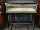 an image of a glass display case sitting on top of a wooden table