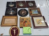 a lot of framed pictures on a table with a clock