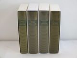 three books sitting on top of a white table next to each other
