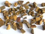 a pile of gold nuggets on a white surface