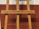 a wooden easel that is sitting on the floor