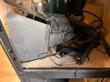 a laptop computer sitting on top of a metal table