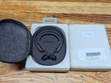 an open box with a pair of headphones in it on a wooden surface