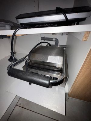 underside view of a toaster and toaster on a shelf in a kitchen