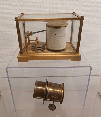 a glass display case with a clock inside of it